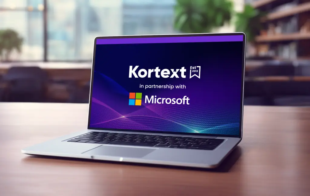 Fusion page - Microsoft partnership button image CEO James Grey in conversation with other Kortext staff at an event