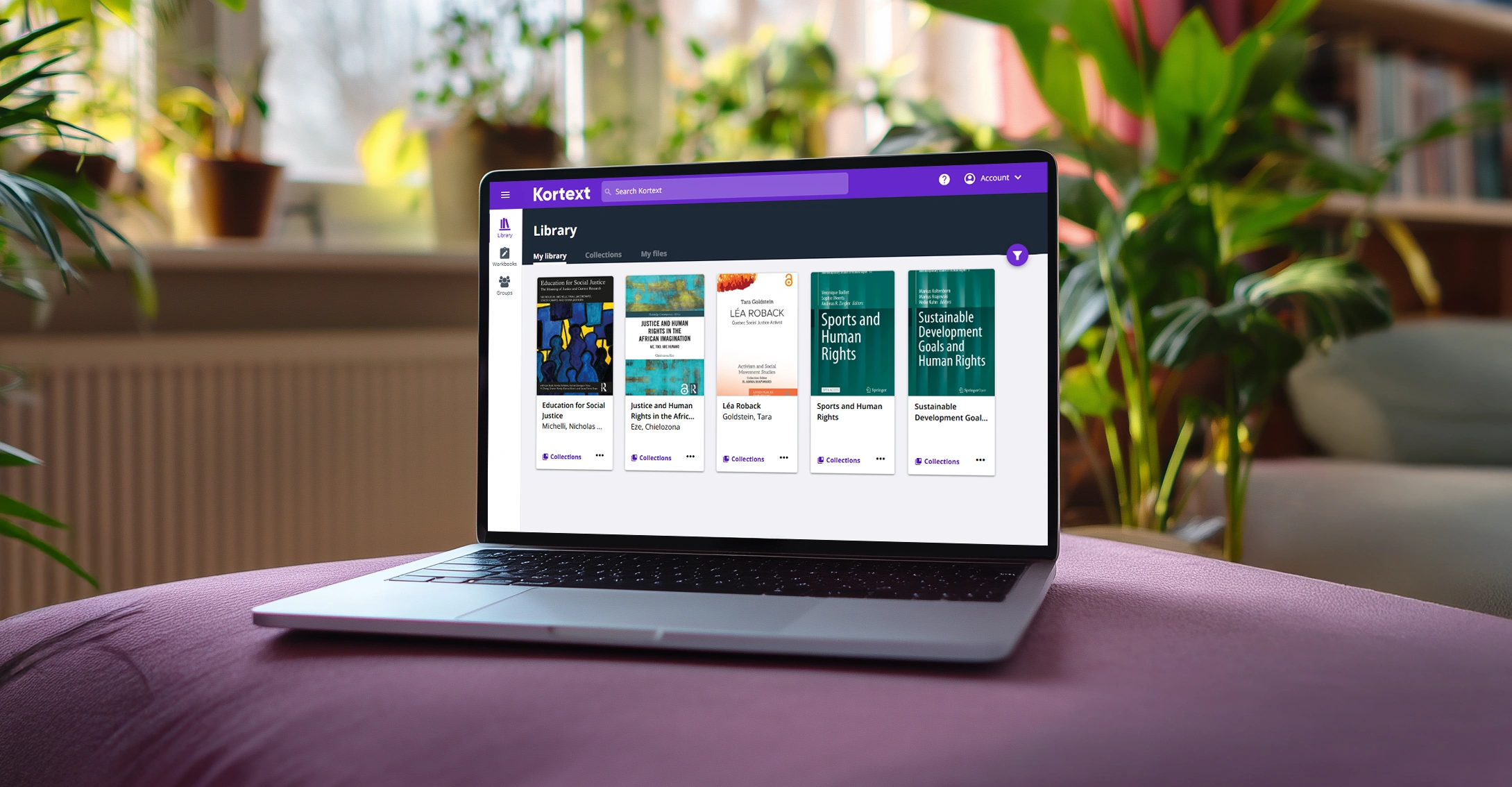 A laptop displaying the Kortext library with five open-access social justice books.