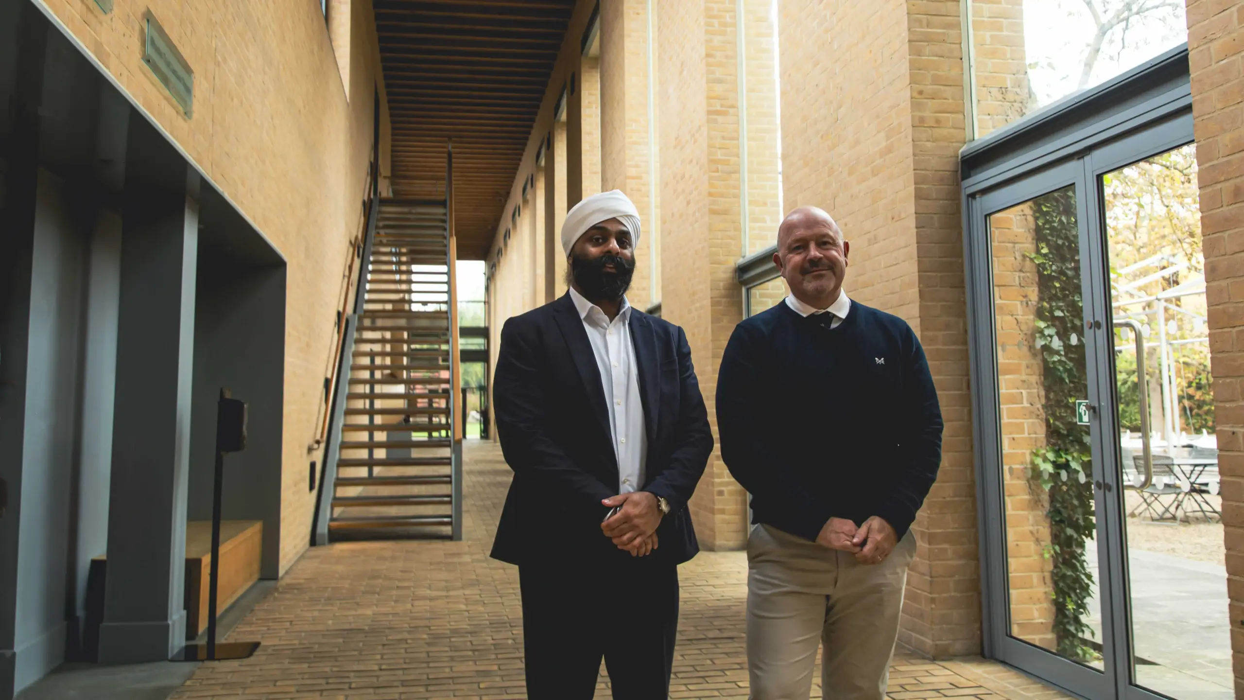 Jyotveer Gill and Mark Bramwell standing together inside Saïd Business School .