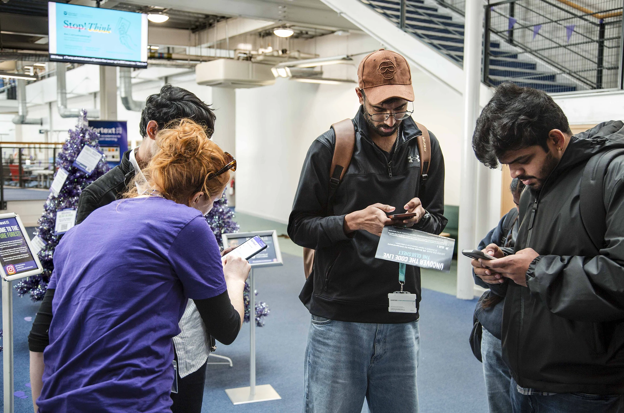 Kortext team member helping students on their phones at a university event
