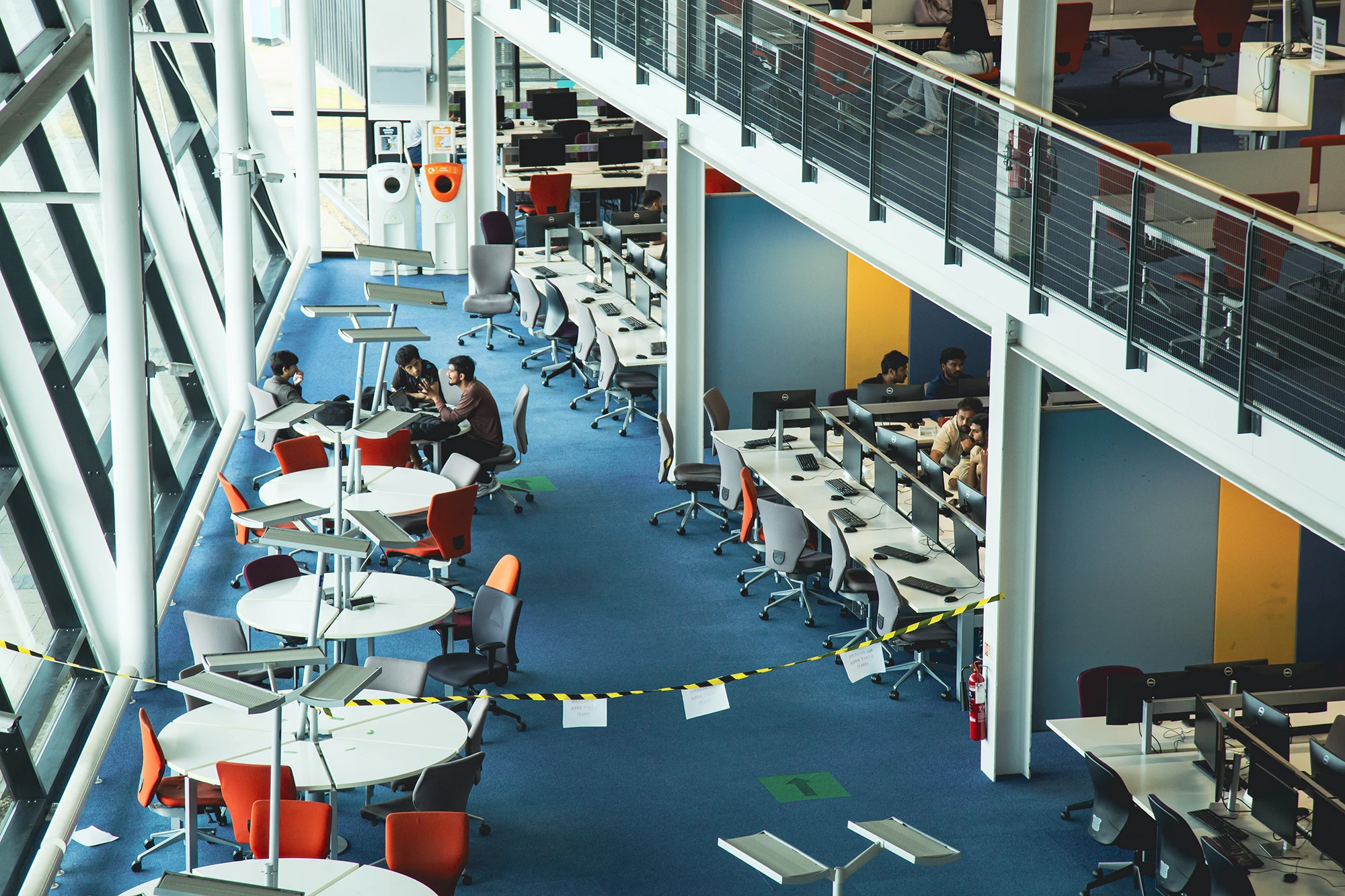 Aerial view of the UEL multi-level library with students studying at computers and tables