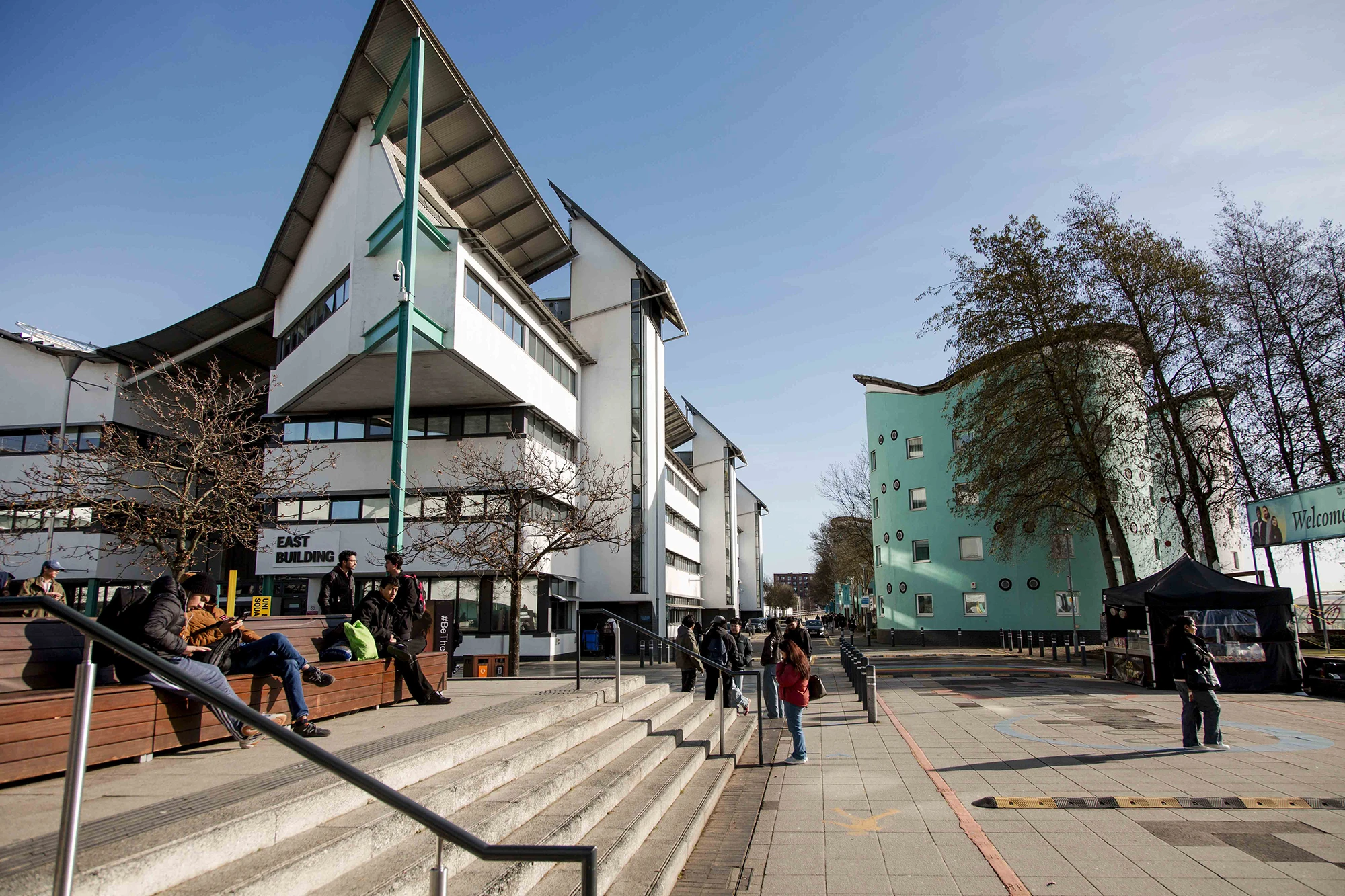 UEL campus exterior with students on steps