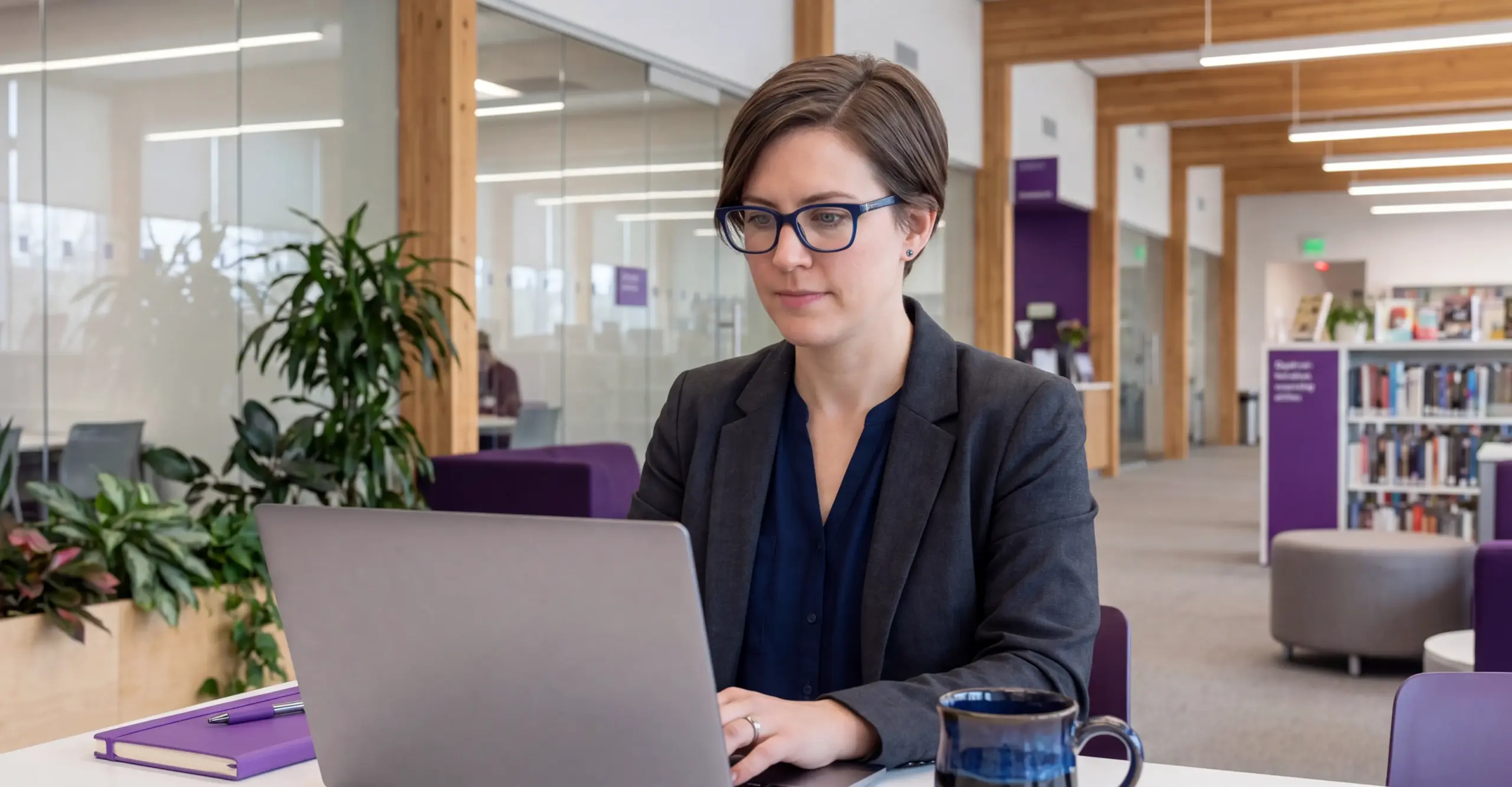 A member of staff sits at her laptop, using Kortext stream to help streamline her workload