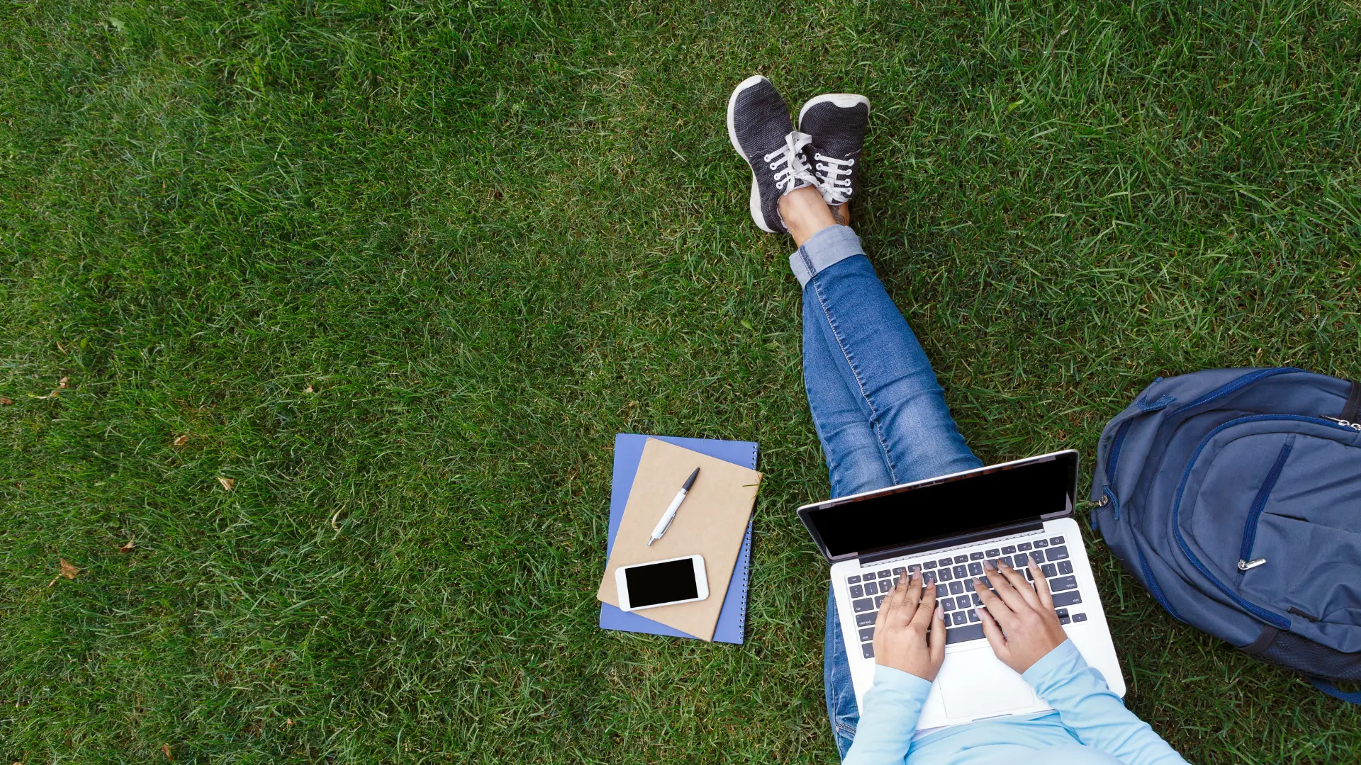 Student studying on grass