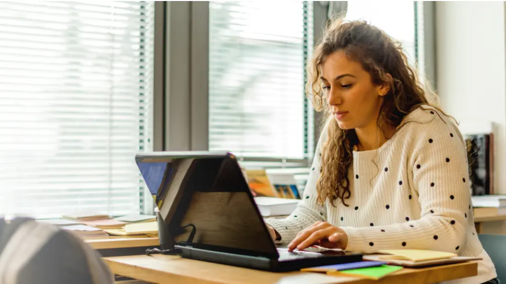 female student studying using laptop