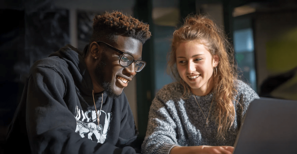 two happy students in conversation
